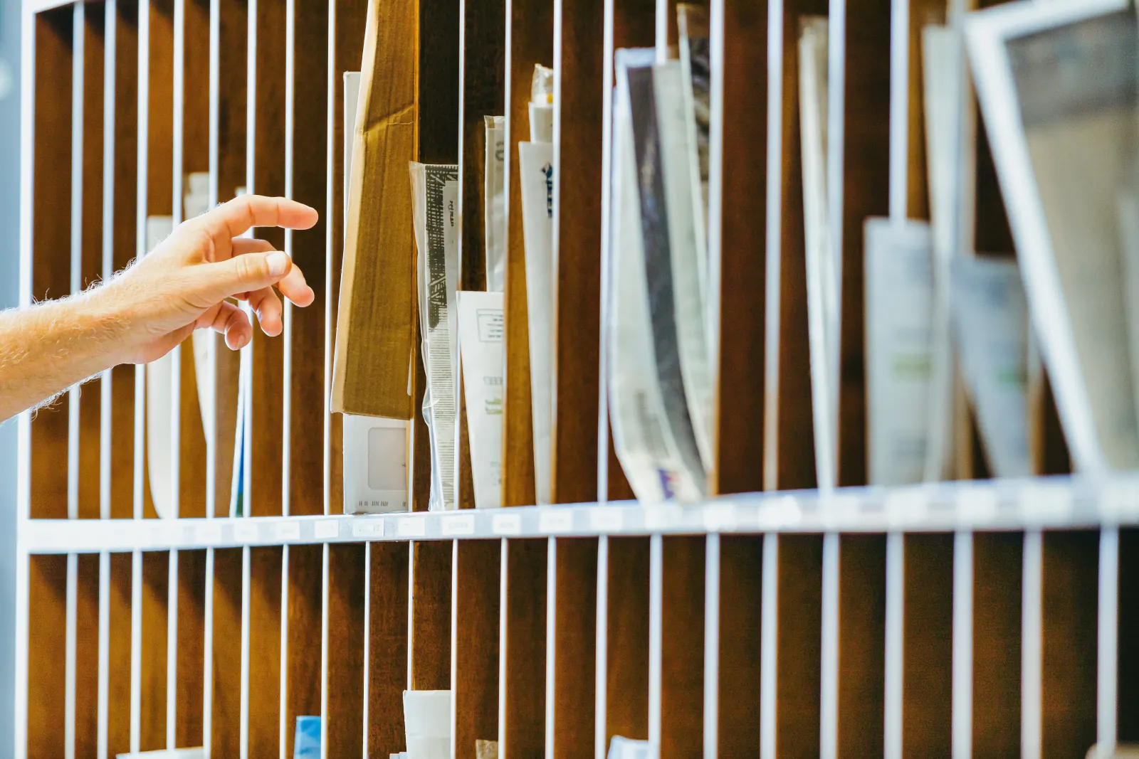 Hand sorting mail into labeled slots in a secure mailroom