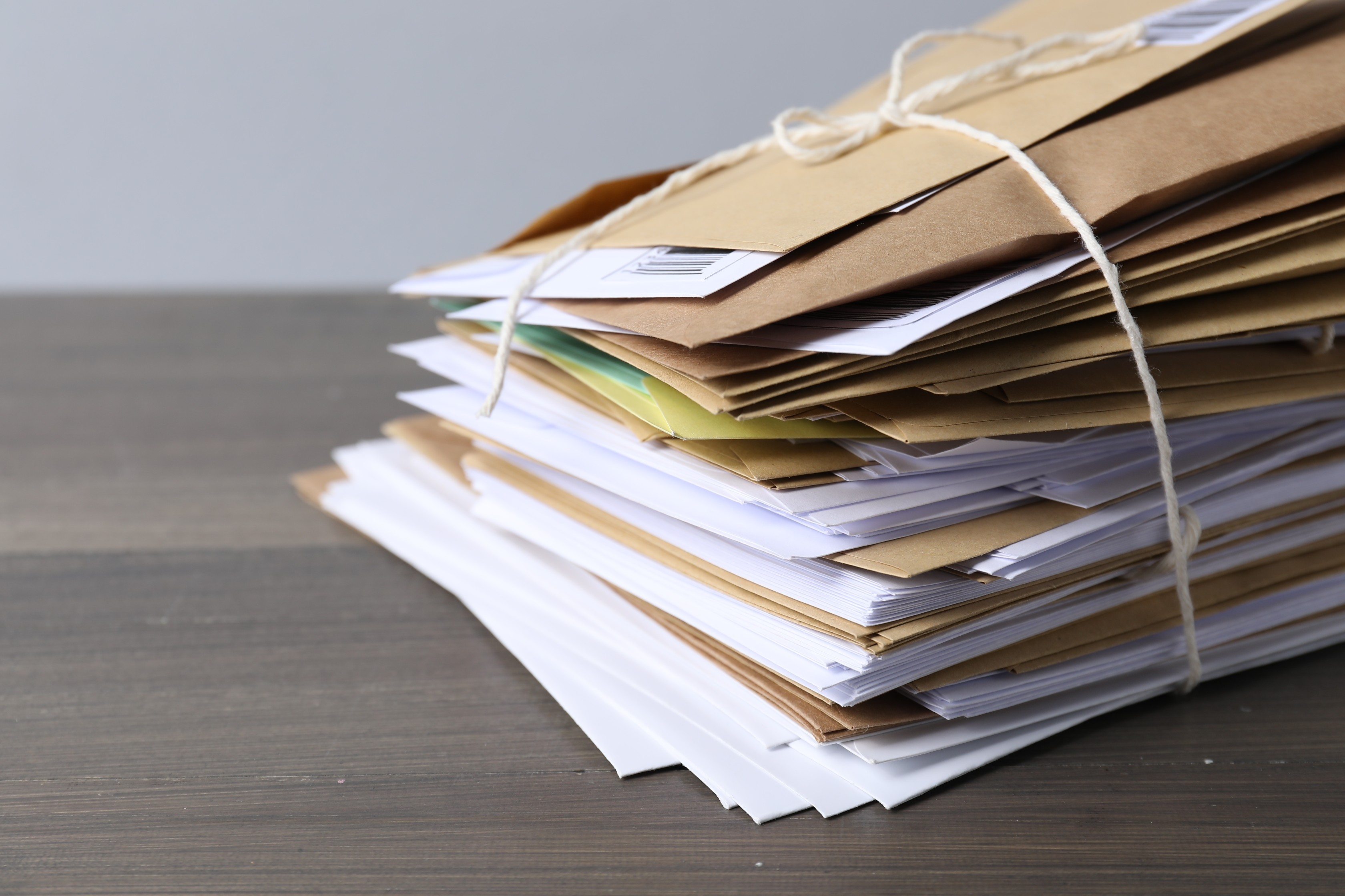 Stack of held mail tied with string ready for bulk forwarding