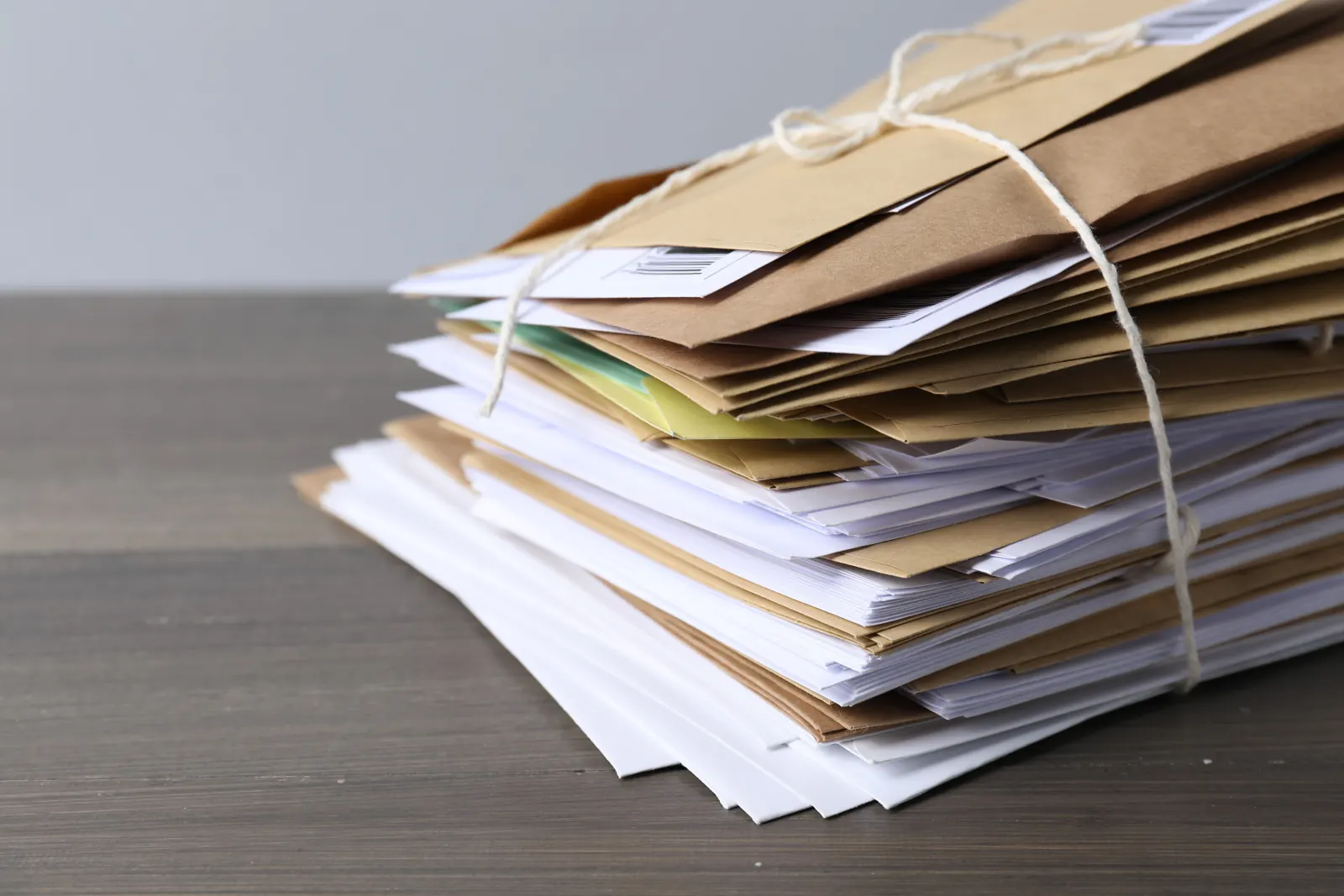 Stack of held mail tied with string ready for bulk forwarding